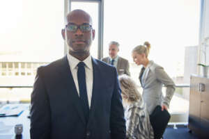 Black businessman standing in front of team