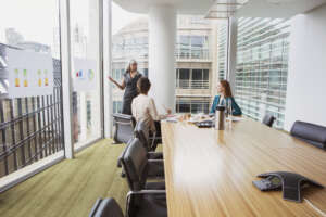 Business meeting in a modern conference room with city view