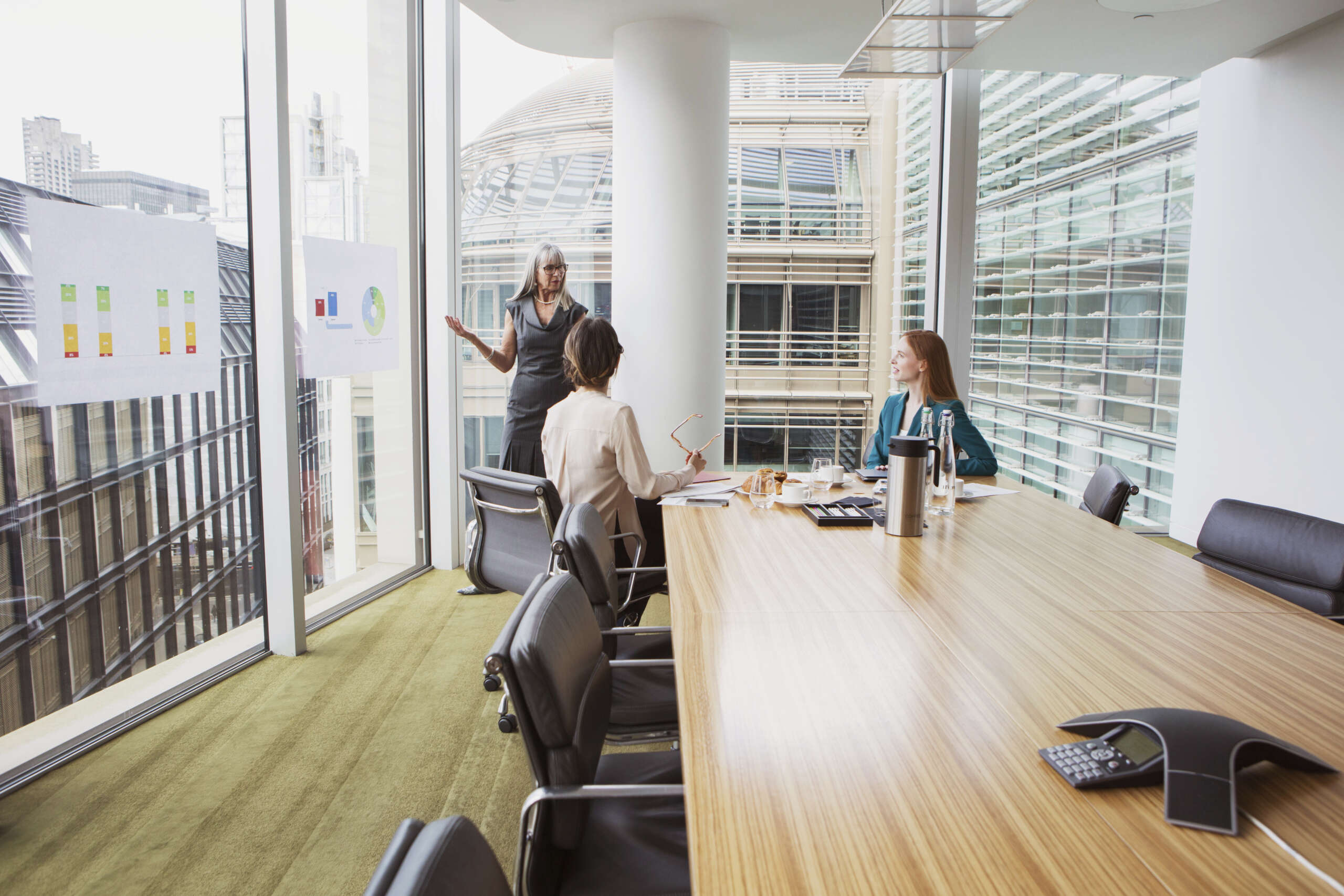 Business meeting in a modern conference room with city view