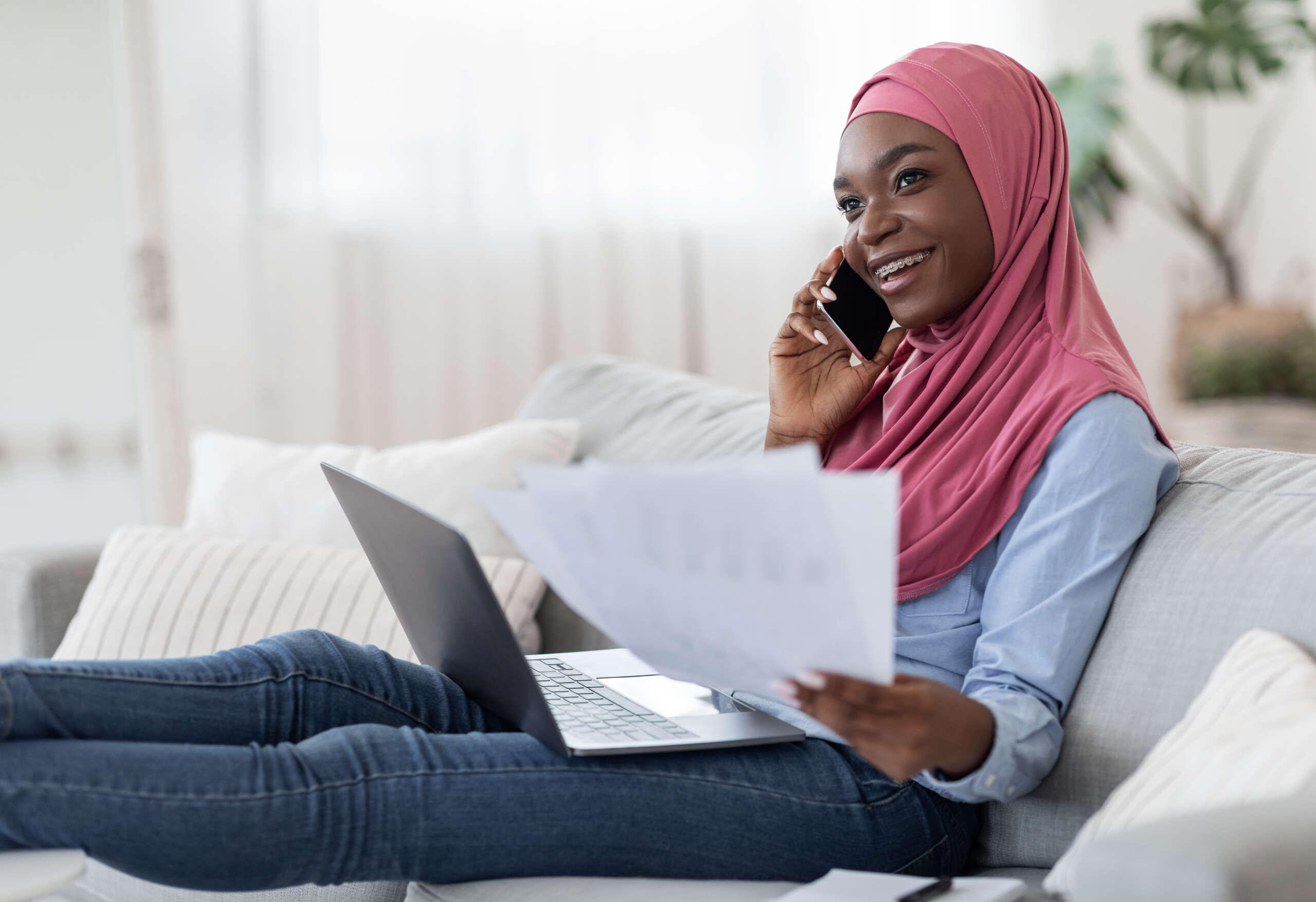 Home Office. Young Black Muslim Freelancer Woman Working With Papers And Laptop